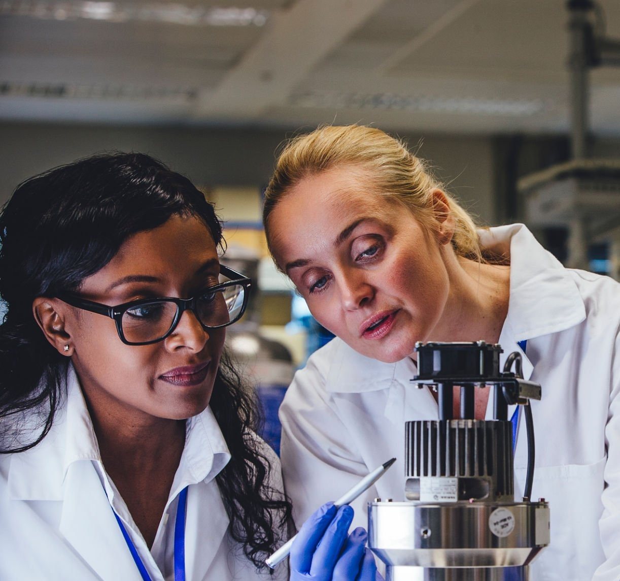 Two specialists reviewing a piece of medical equipment together