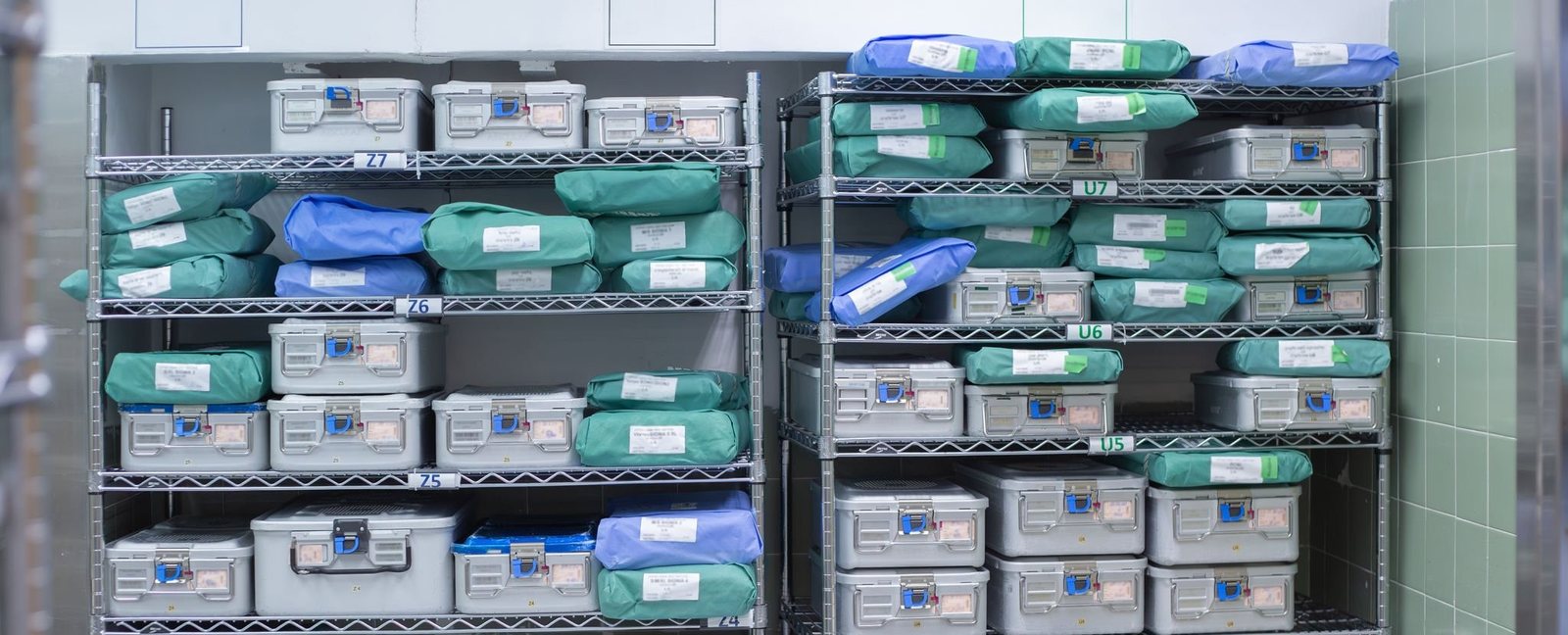 Labeled instrument trays stored on clinical supply shelves